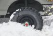 Four wheel vehicle tyre trapped on the snow. Winter time