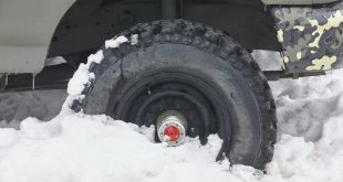 Four wheel vehicle tyre trapped on the snow. Winter time