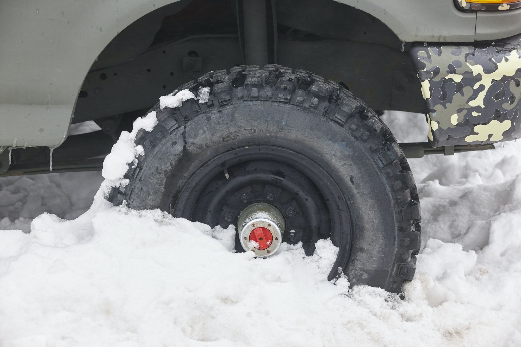 Four wheel vehicle tyre trapped on the snow. Winter time