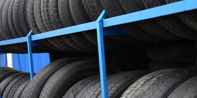 Rack with variety of car tires in automobile store