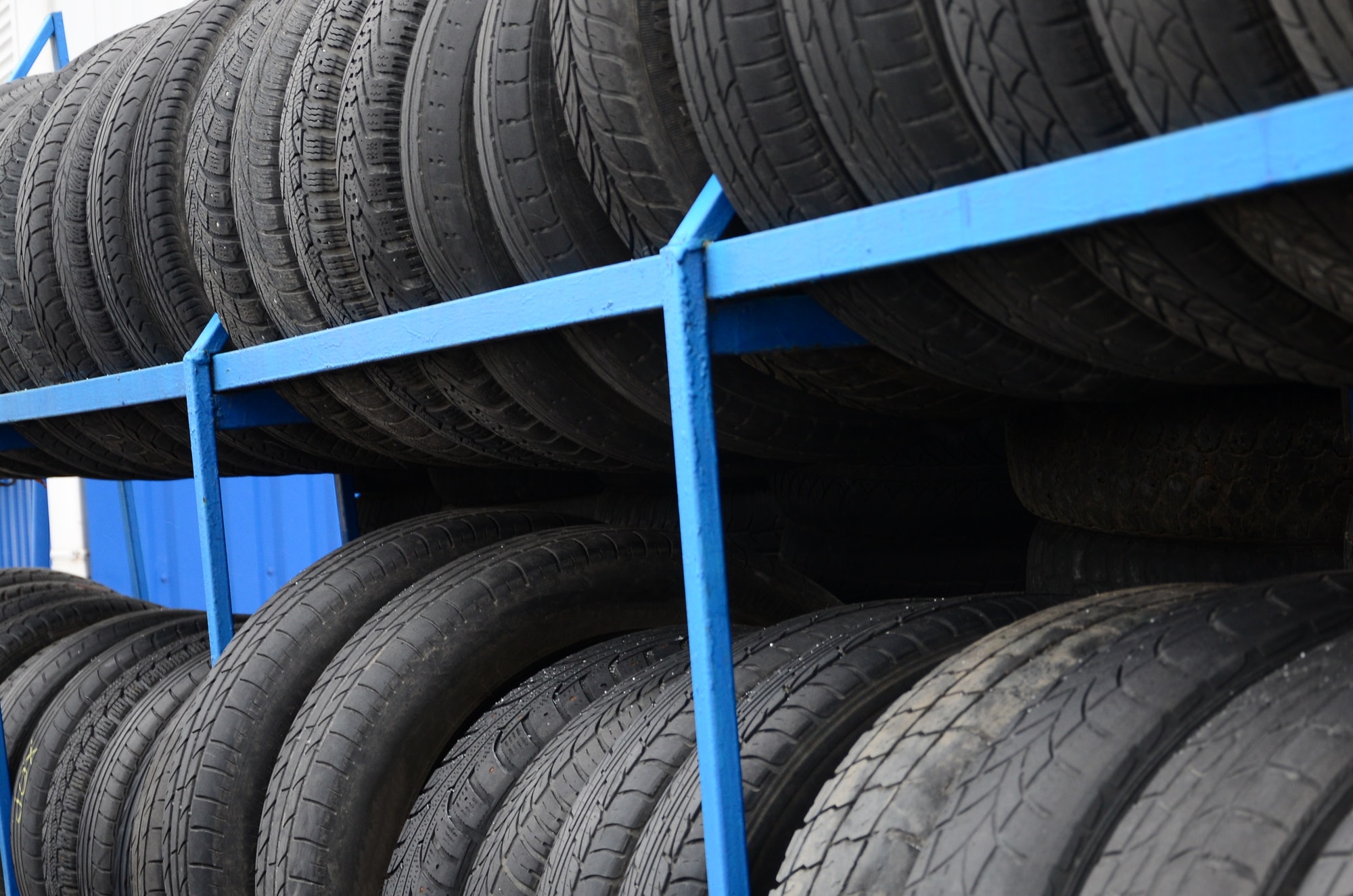 Rack with variety of car tires in automobile store