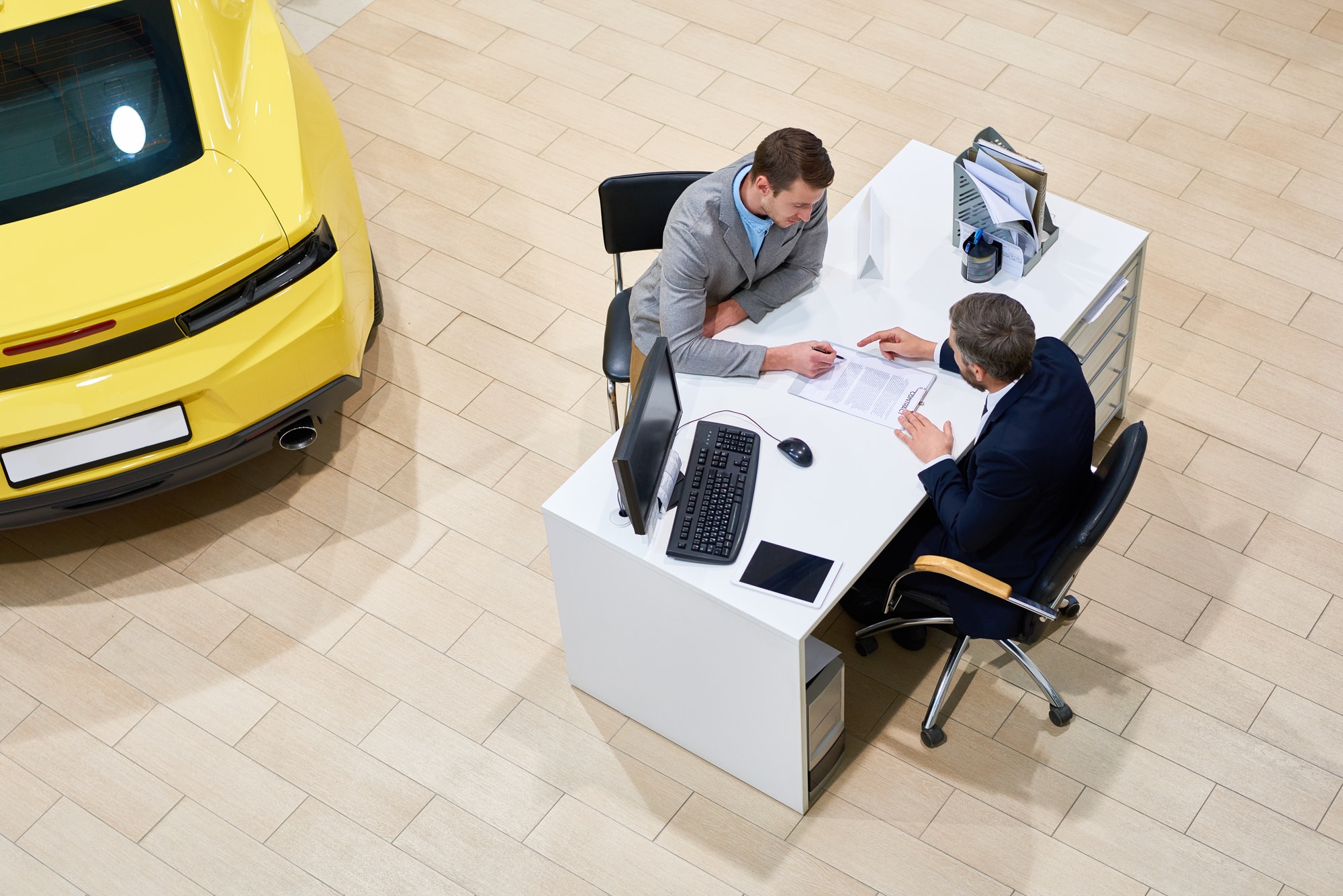 Client Signing Papers to Buy Car