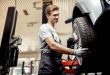 An automechanic changes a tire while at work at a car repair service