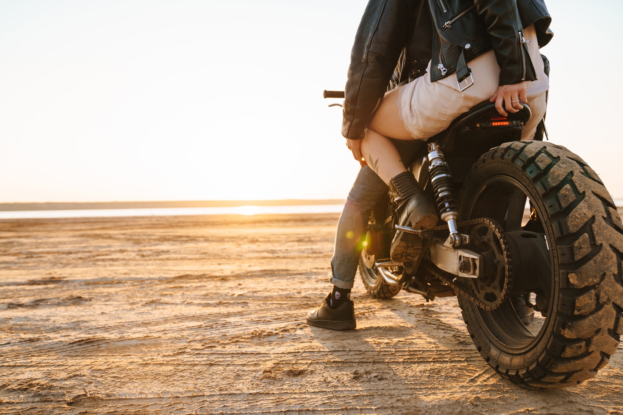 Beautiful young stylish couple enjoying ride on a motorbike
