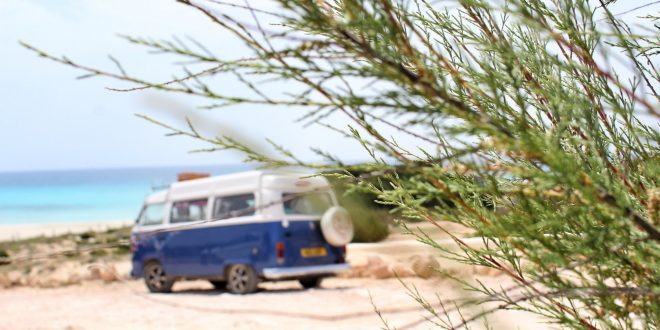 Camper van parked by a beach