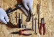 car drum brake disassembled in men's hands and a set auto mechanic's repair hand tools kit flat lay