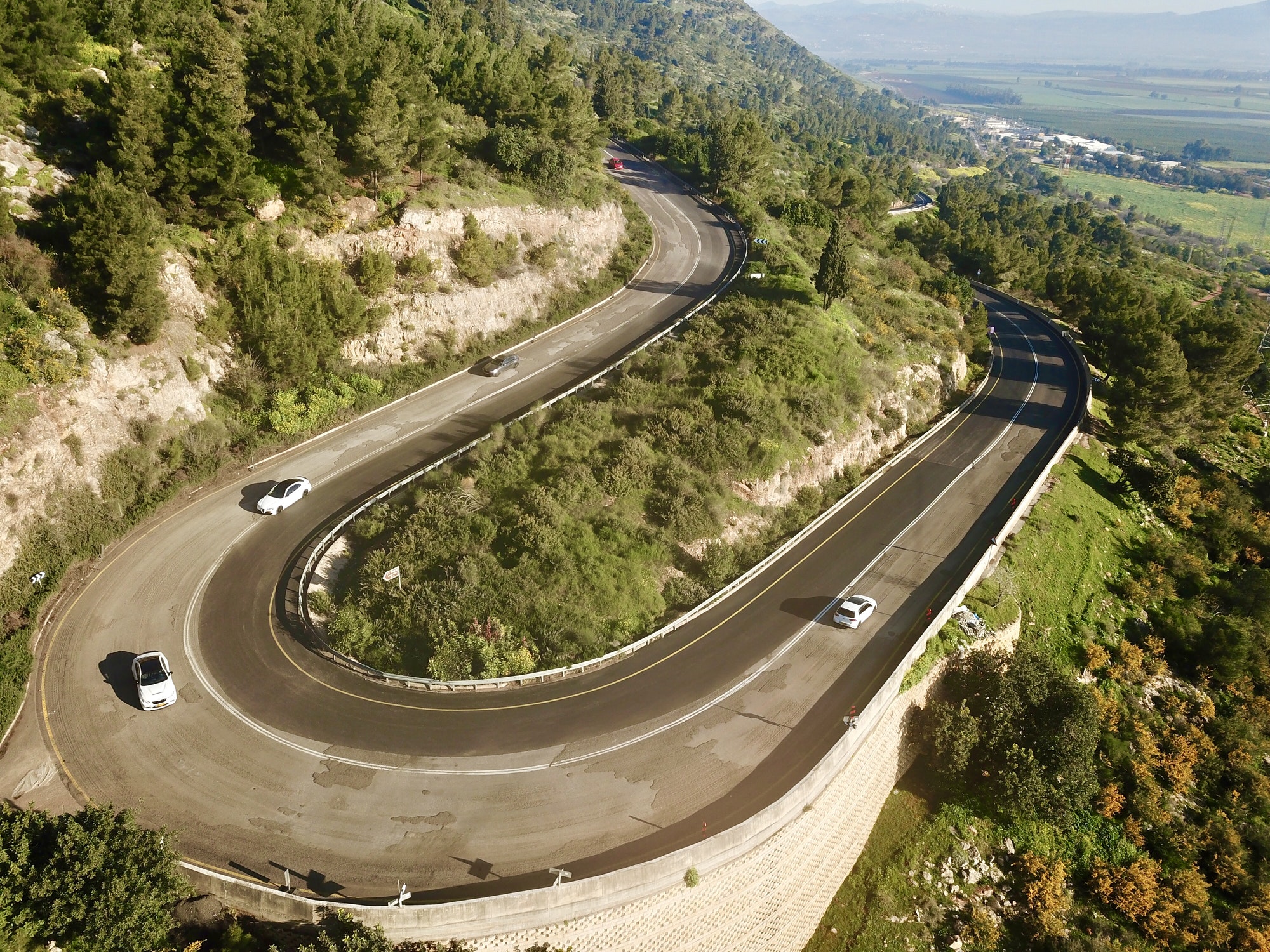 Cars turning left in a sharp curve