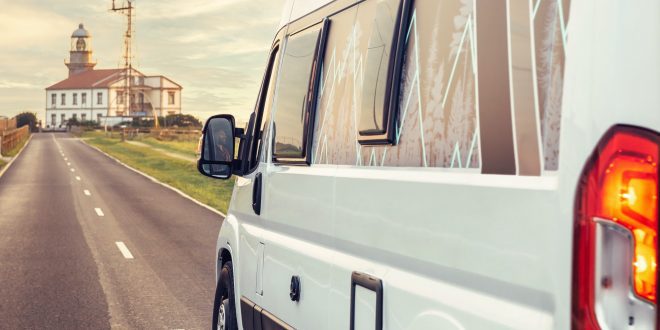 Closeup of camper van traveling to a lighthouse