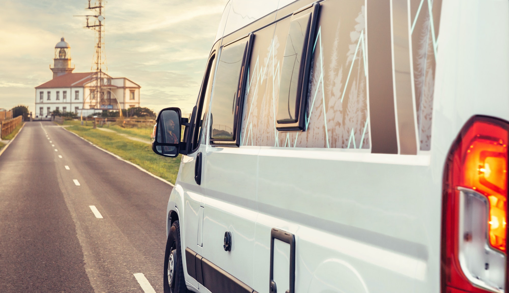 Closeup of camper van traveling to a lighthouse