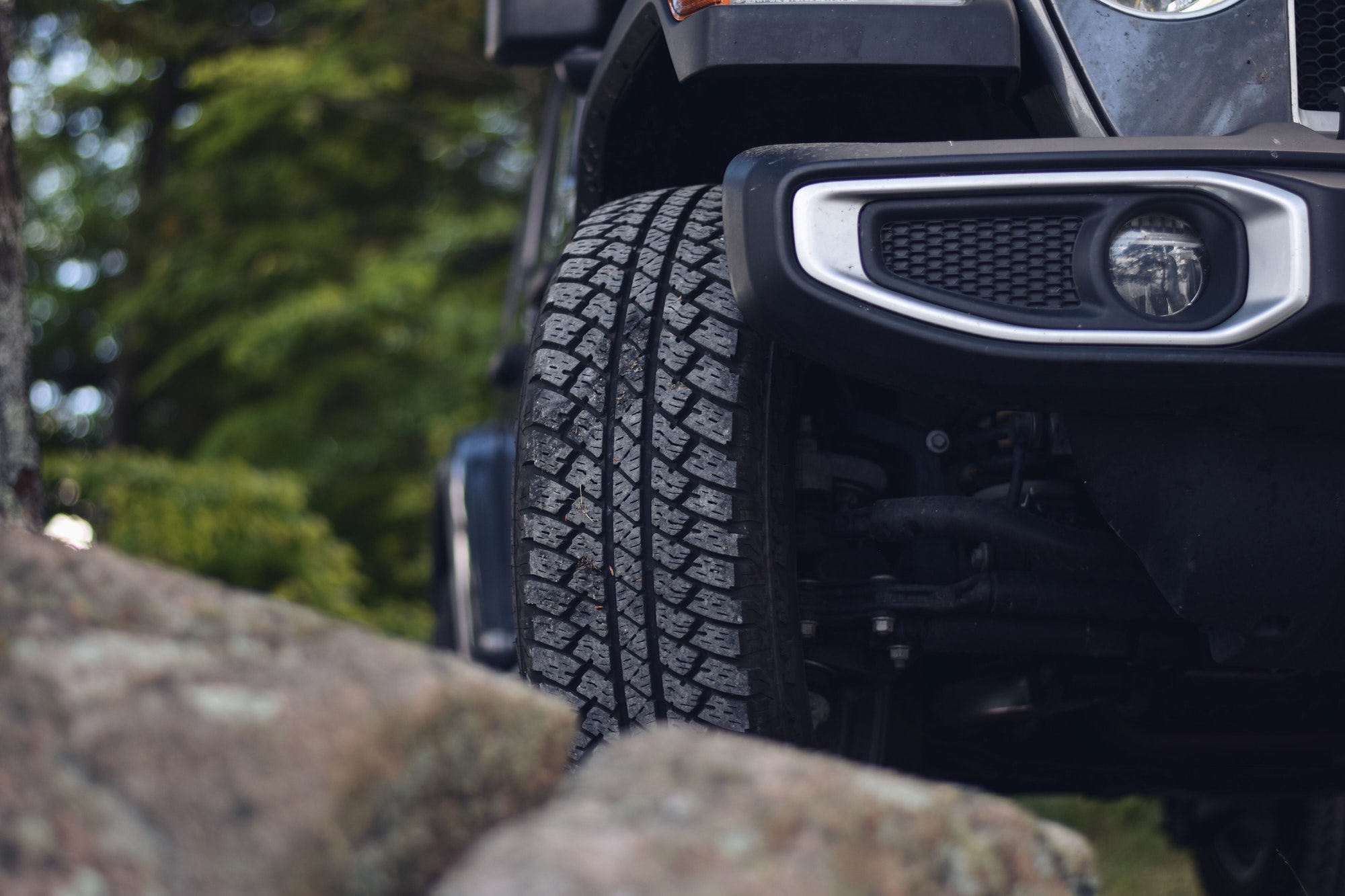 Closeup on a front tire of jeep, adventure is waiting