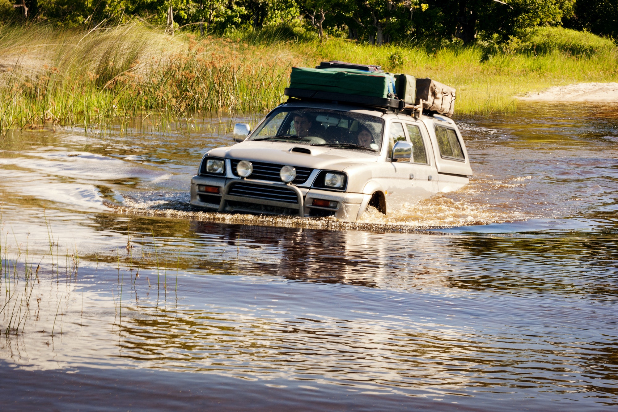 Couple Enjoying Off-road Vehicle Ride In Pond