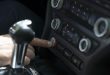Crop man starting car with button