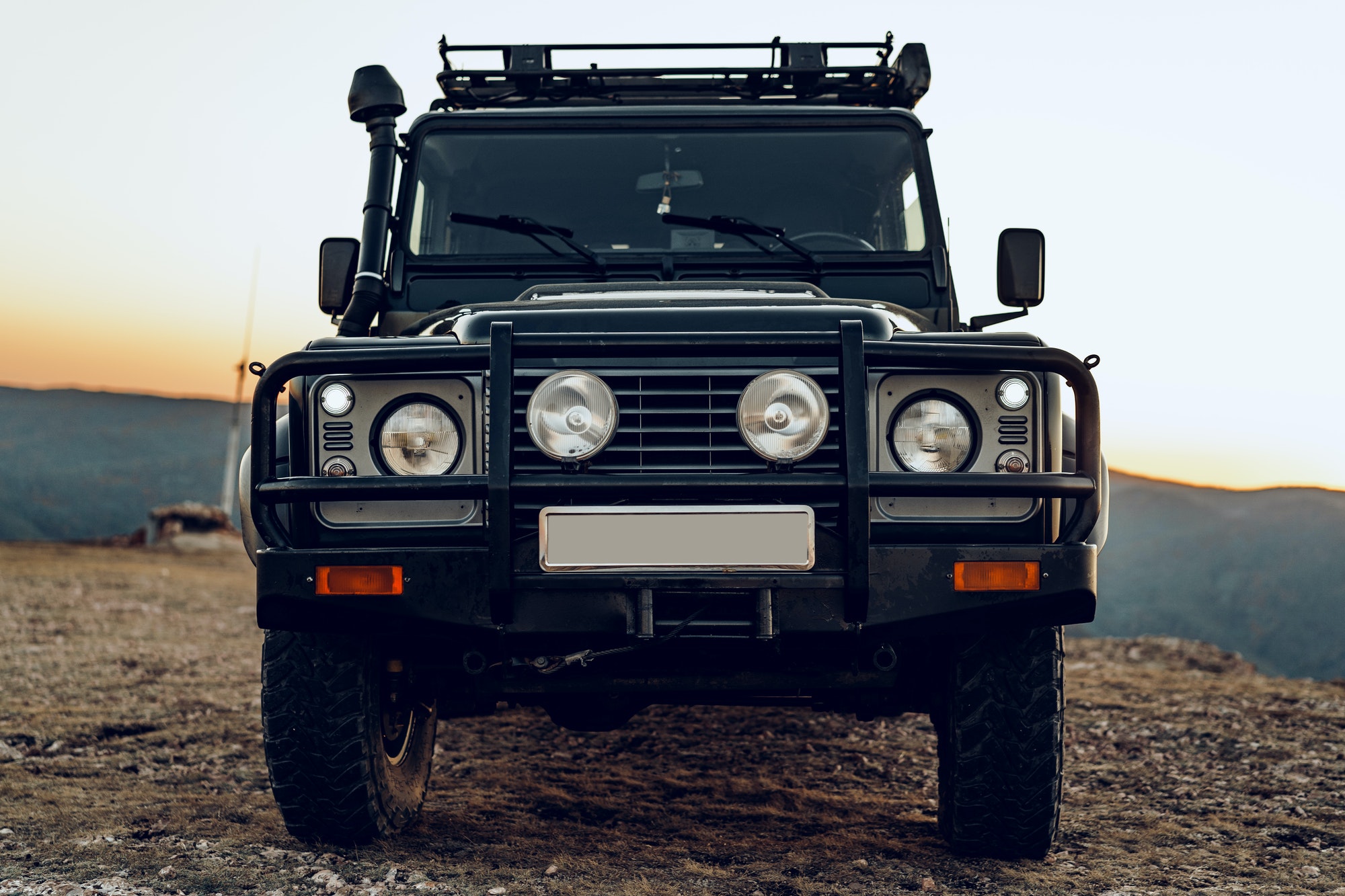 Dark green off-road car in the mountains