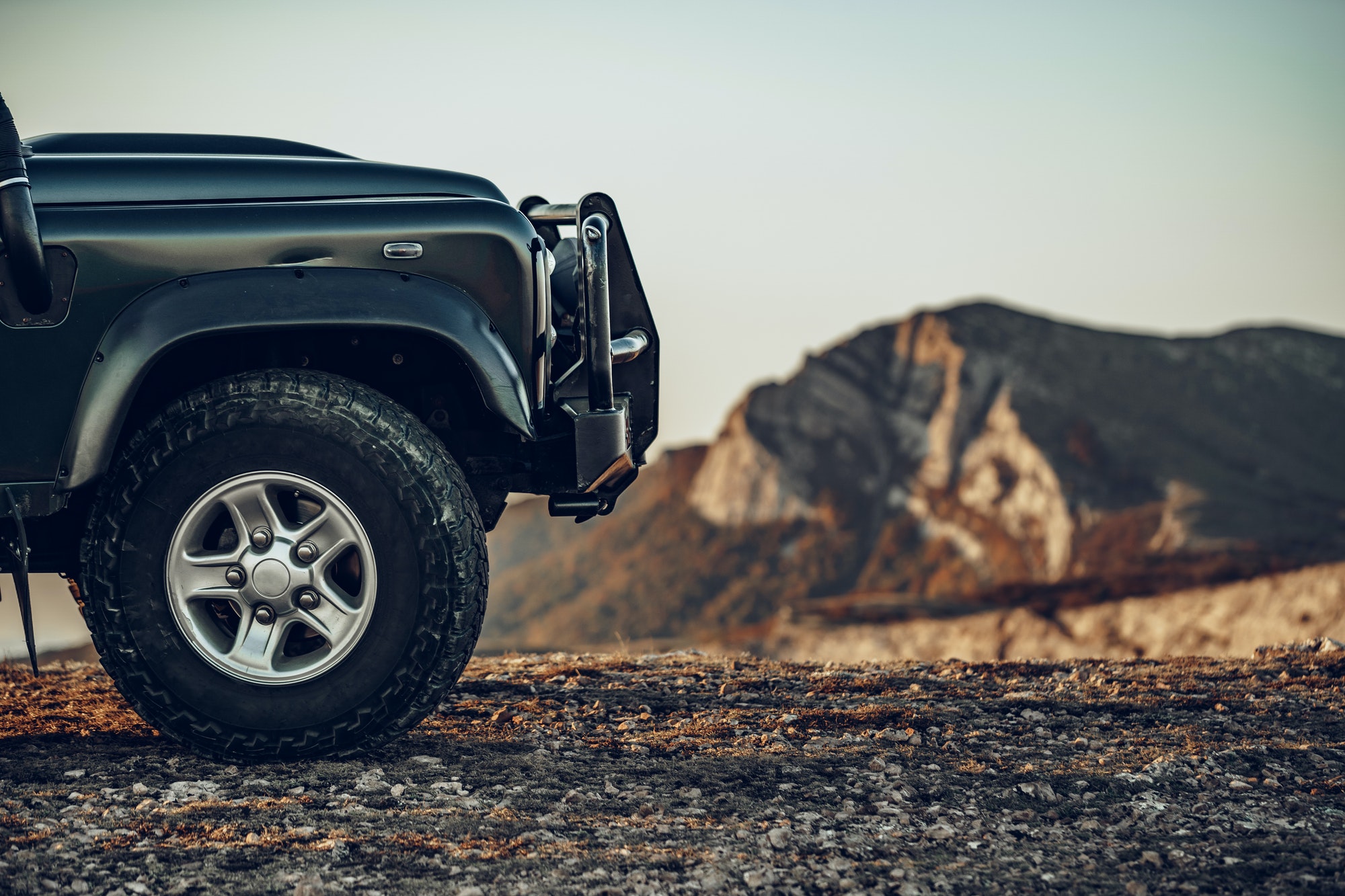 Dark green off-road car in the mountains