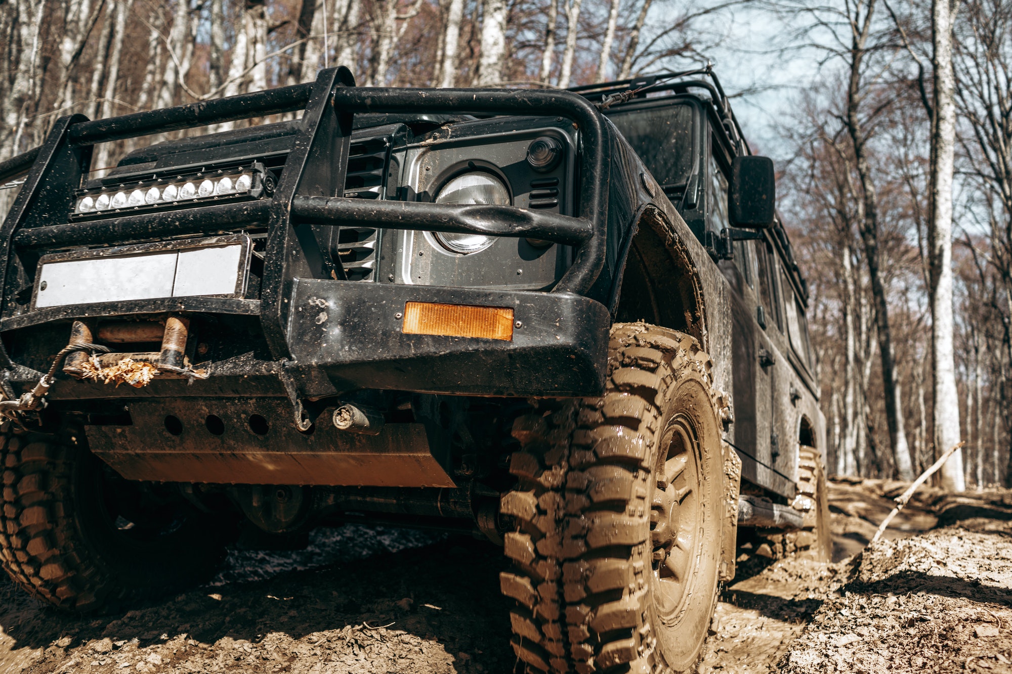 Dirty off road car on trip in forest