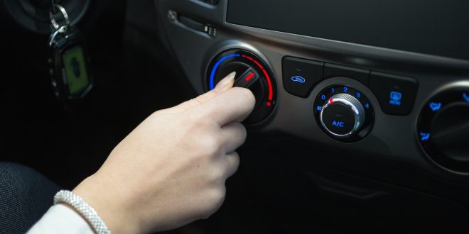 driver turning car air conditioner knob