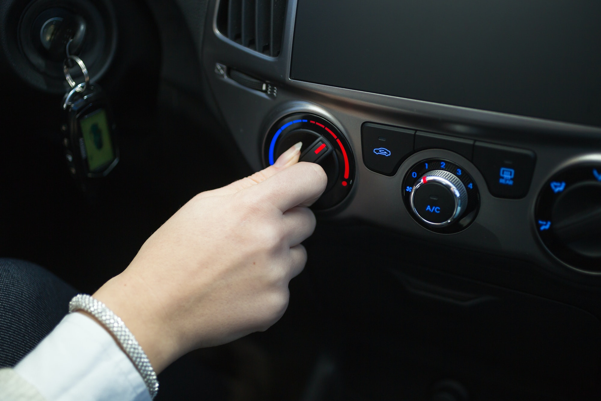driver turning car air conditioner knob