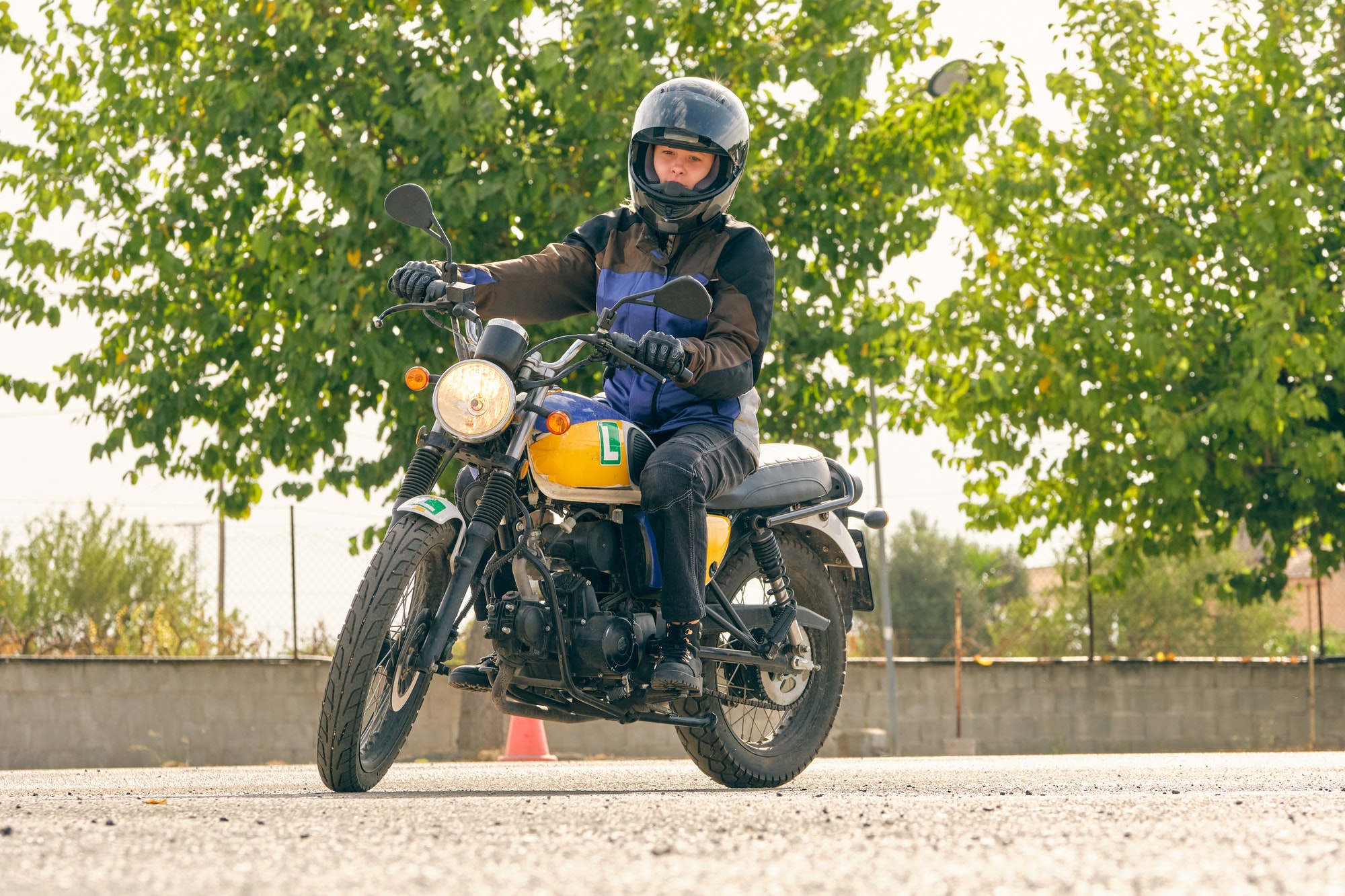 Focused motorcyclist riding motorbike on motordrome