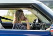 Frustrated female driver sit inside car with chin on hands scared to drive after vehicle accident