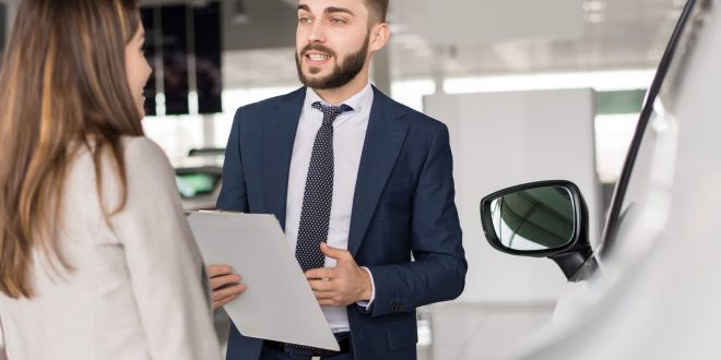 Handsome Car Salesman Selling Cars