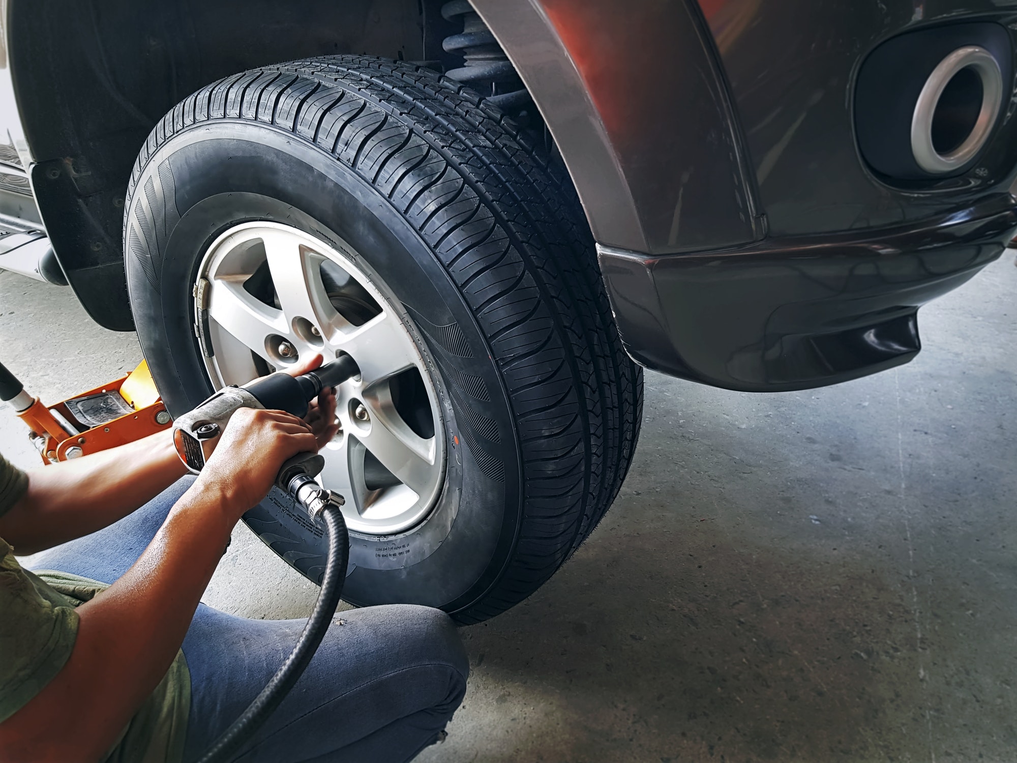 High Angle View of Mechanic Changing Front Wheel Tire