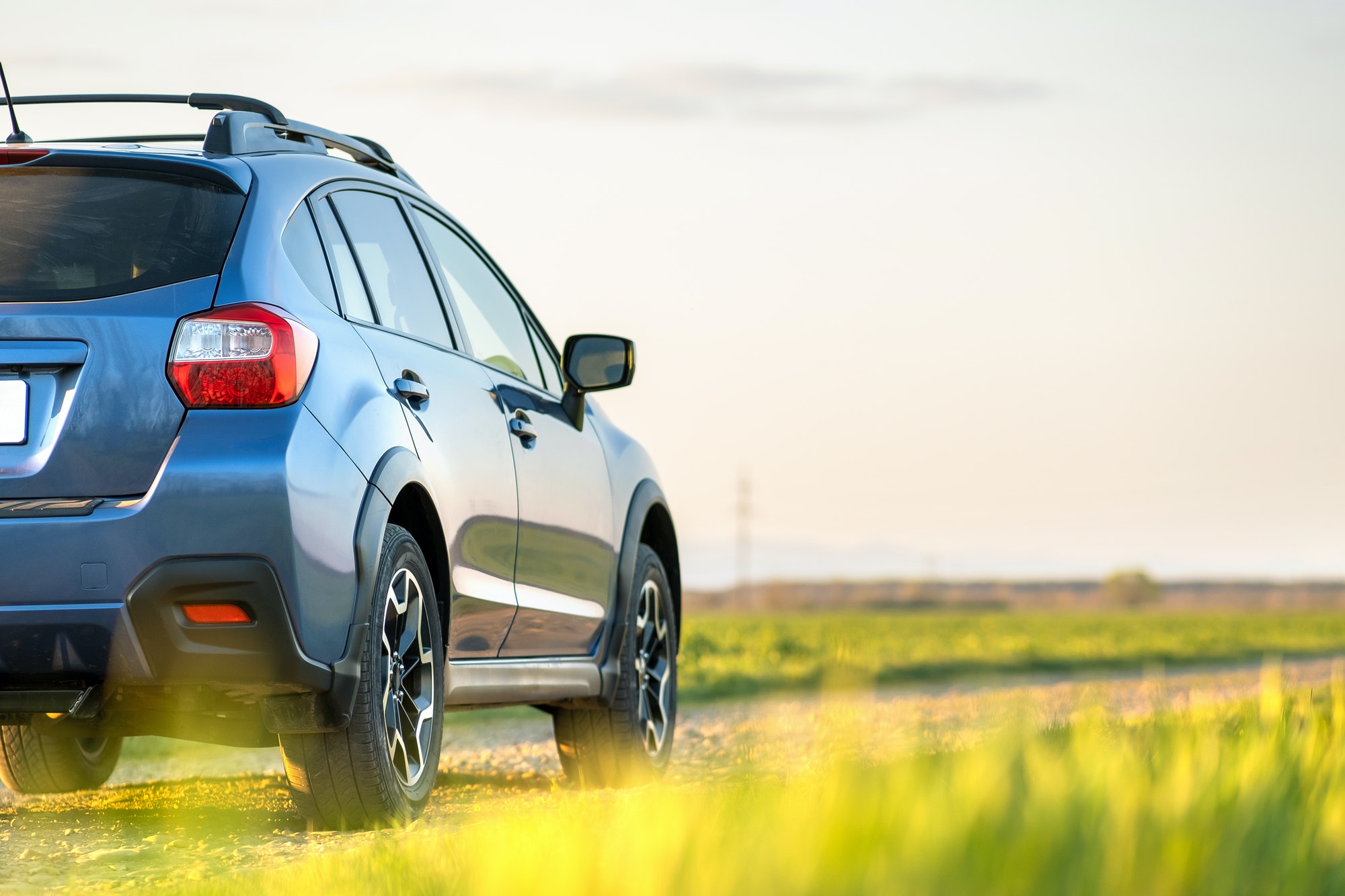 Landscape with blue off road car on gravel road. Traveling by auto, adventure in wildlife