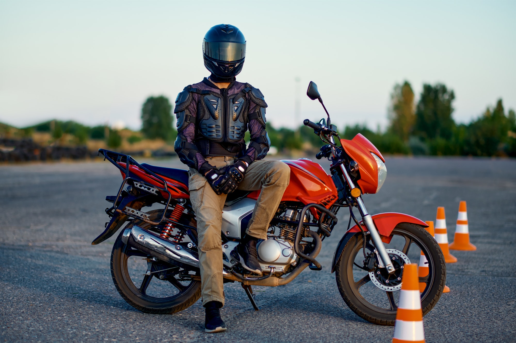 Male student poses on motorbike, motorcycle school