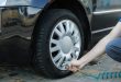 Man pumps up tires. Car inspection. Maintenance