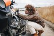 Man tries to fix motorbike on road side