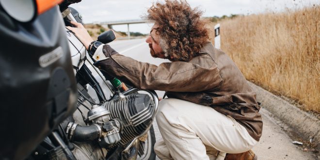 Man tries to fix motorbike on road side