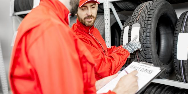 Men working in the warehouse with tires