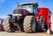 Modern red agricultural tractor in a farm