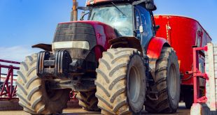 Modern red agricultural tractor in a farm