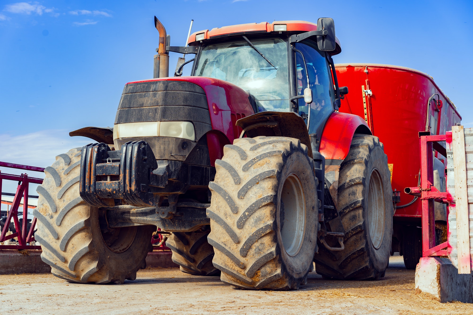 Modern red agricultural tractor in a farm