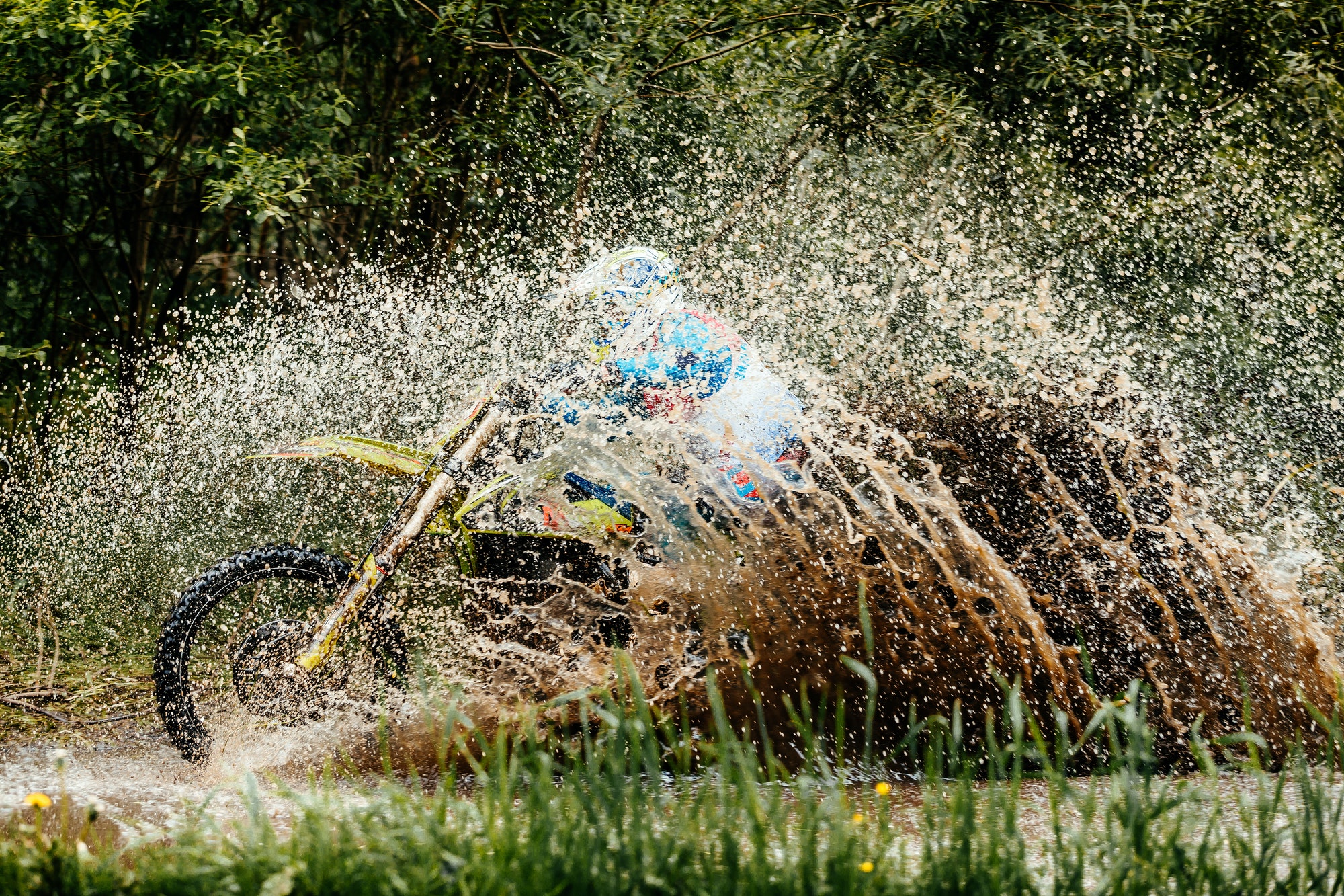 motorcycle rider crosses puddle