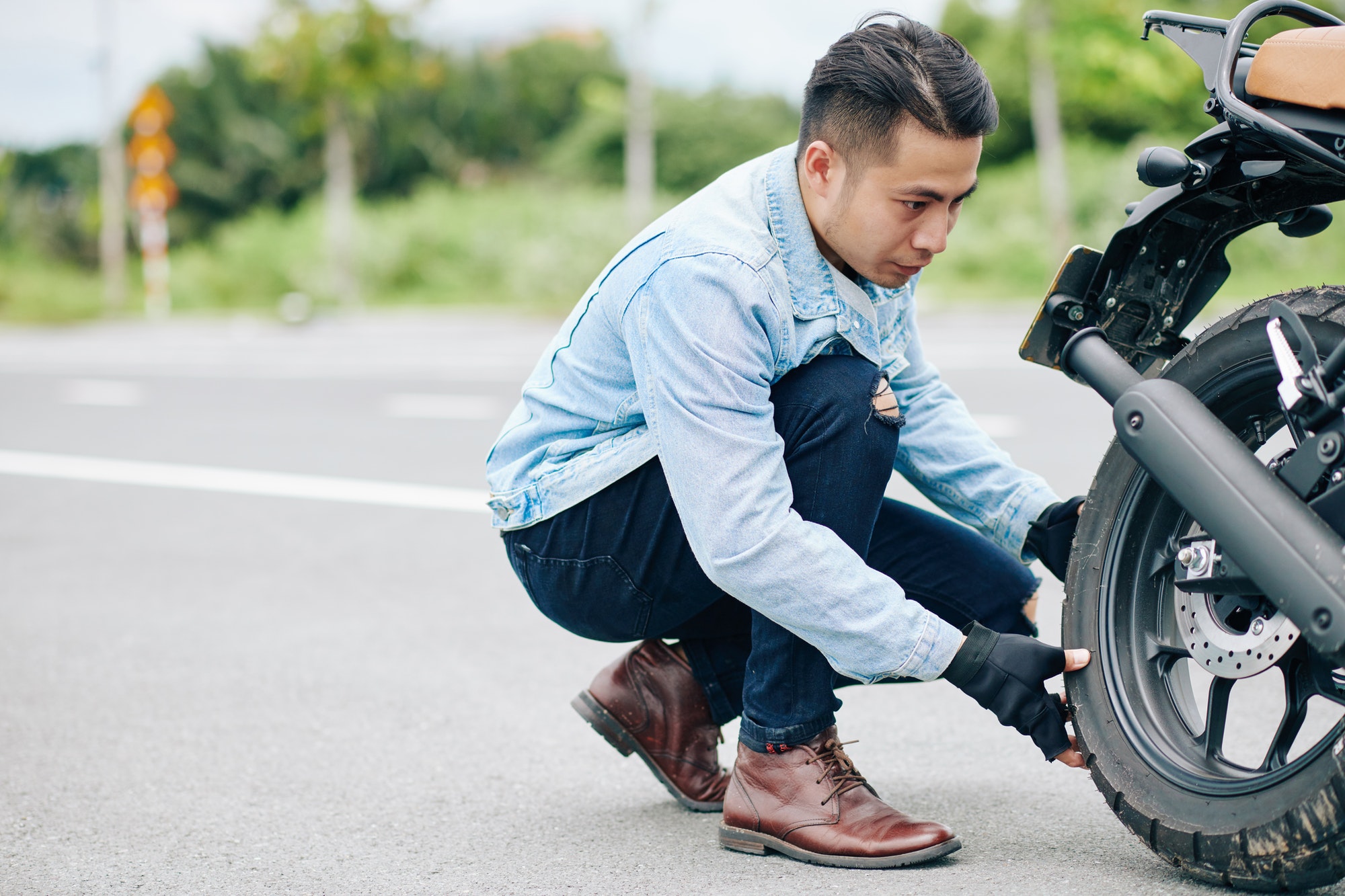 Motorcyclist taking off tire