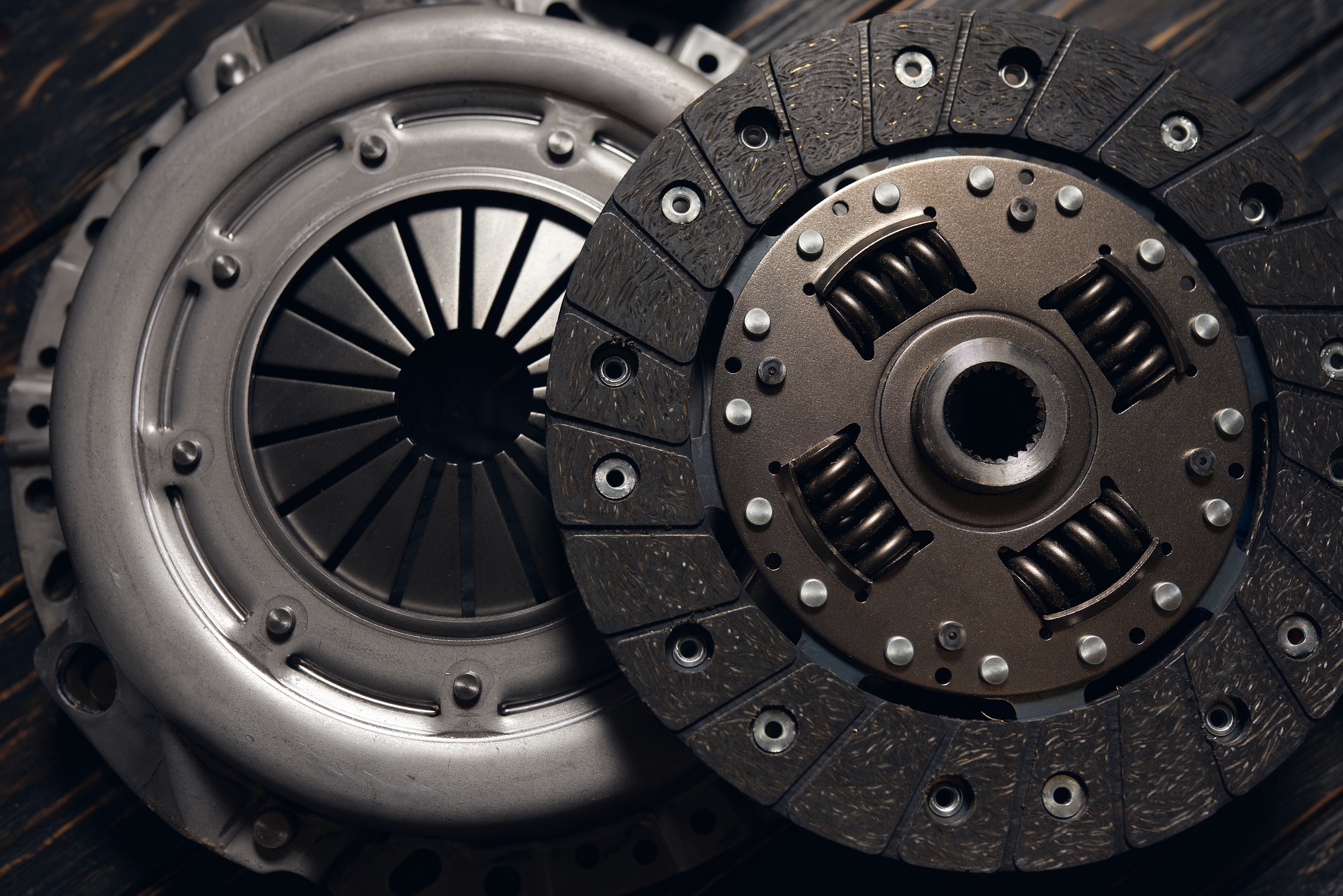 new car clutch kit on a dark wooden background. Close up