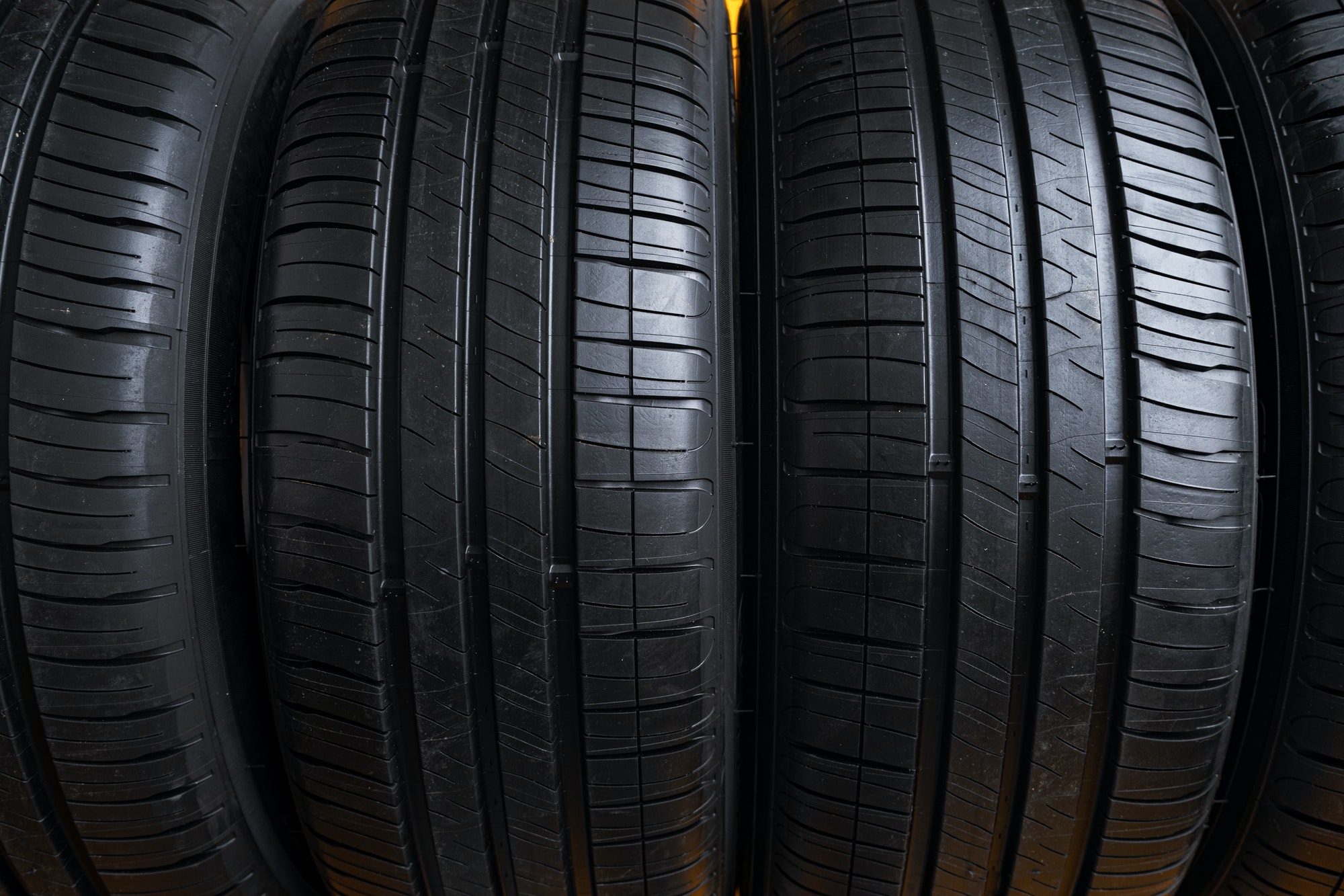 Row of new car tires close up.