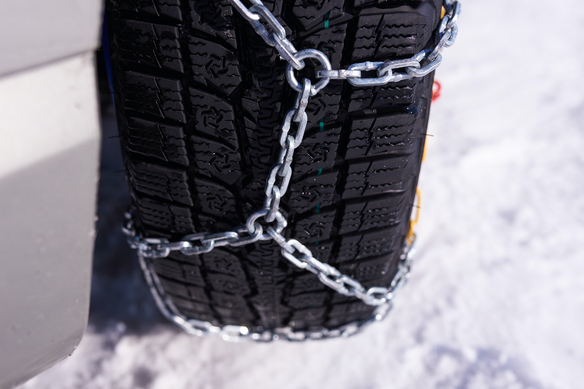 snow chain on a wheel in deep snow in winter