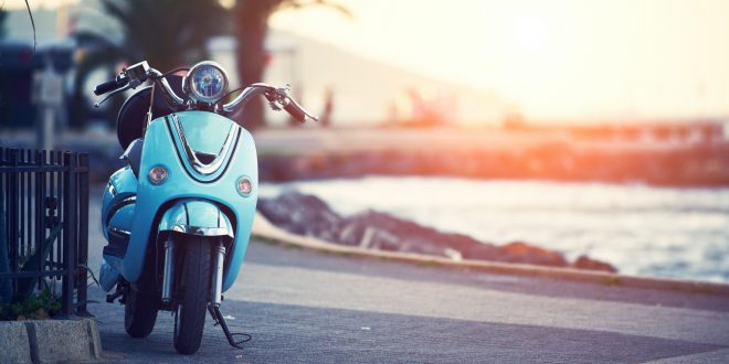 Vintage motor scooter Vespa, traditional bike in the pictursque pier of Buyukada, Istanbul at sunset