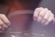 Woman's hands on steering wheel of a car