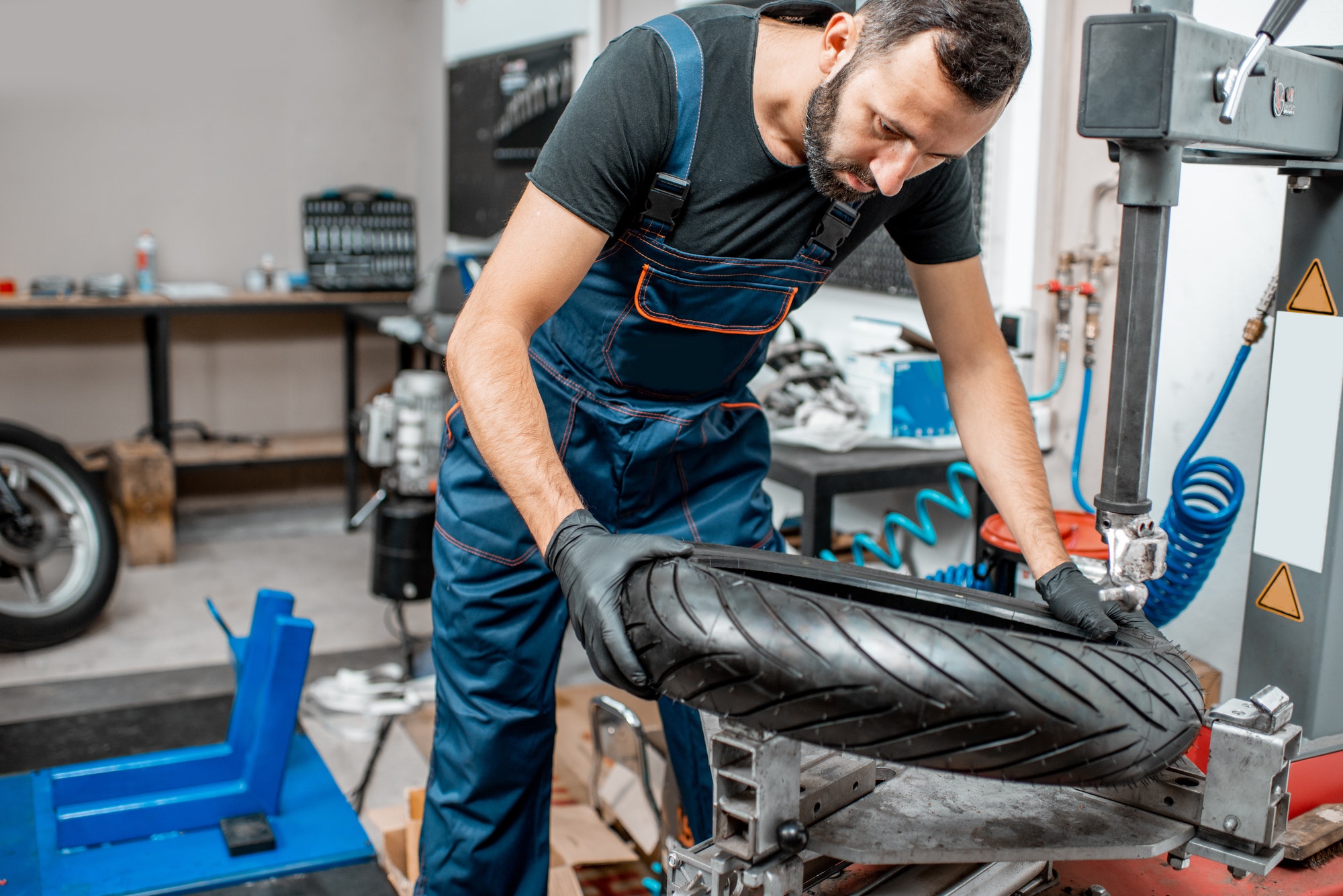 Worker changing a motorcycle tire