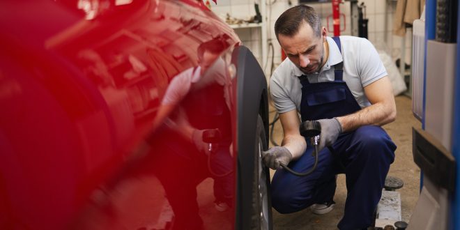 Mechanic Checking Car Tires