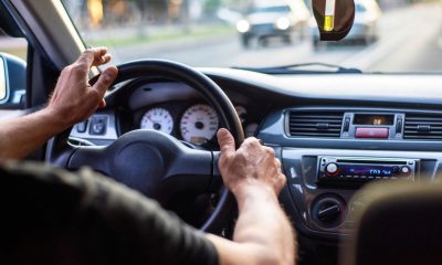 A man driving a car with cigarette