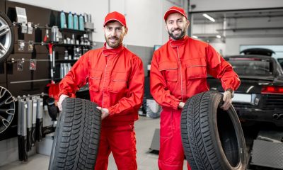Car service workers with new tires at the shop