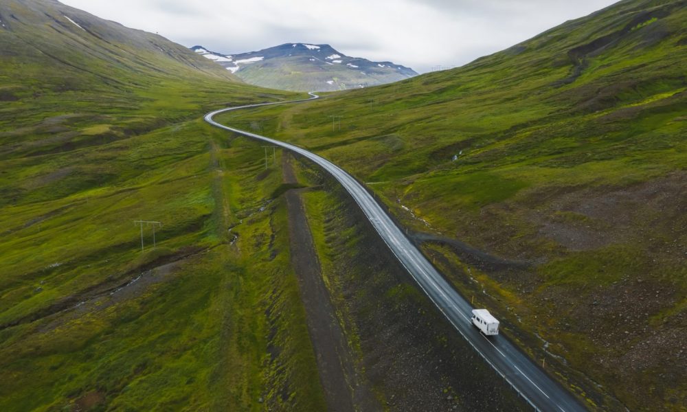 Lonely rent van transporter car drive on remote road with beautiful scenery of Iceland
