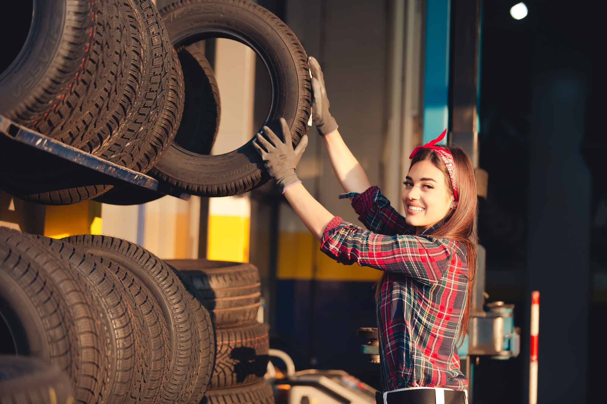 Girl mechanic changing tires
