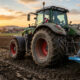 Tractor moderno equipado con equivalencia neumaticos agricola trabajando sobre terreno agrícola con máxima tracción, estabilidad y menor compactación del suelo gracias a neumáticos homologados y tecnología avanzada.